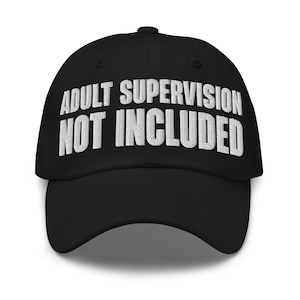 May include: Black baseball cap with white embroidered text that reads "ADULT SUPERVISION NOT INCLUDED". The cap has a curved brim and a button on top. A casual accessory.
