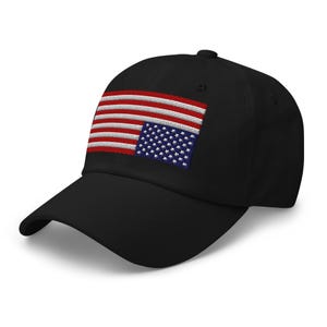 May include: A black baseball cap with an embroidered American flag on the front. The flag is upside down, with the stars on the bottom and the stripes on the top.