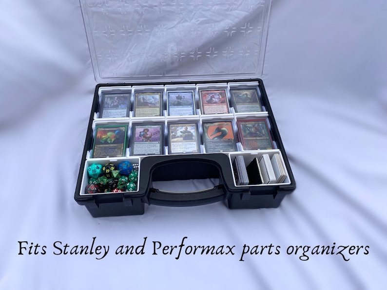 May include: Black plastic storage case with a clear lid and white dividers. The case is filled with small cards and dice. The case has a handle and the text "Fits Stanley and Performax parts organizers" is printed below the case.