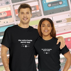 May include: Two people wearing black t-shirts with white text that reads "the voice inside MOYE YEAD" and a graphic of a music player with a play button. The text is centered on the shirts.