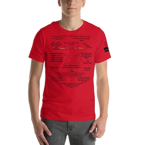 May include: A red t-shirt with black text and graphics. The shirt features various quotes and illustrations, including the phrase "I'M ALL FIRED UP" and the words "DON'T QUIT!" The design is centered on the front of the shirt.