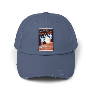 May include: A distressed blue baseball cap with a vintage poster of the play "It Can't Happen Here" by Sinclair Lewis. The poster features a red and white design with the words "President Theatre" and "May 6789".