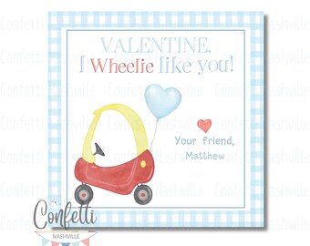 May include: A red and yellow toy car with a blue heart balloon attached to the back. The card has the text "VALENTINE. I Wheelie like you!" and "Your friend, Matthew".