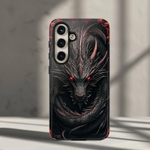 May include: Black phone case featuring a detailed dragon design. The dragon has red eyes and accents, set against a dark background. The case has a glossy finish and a camera cutout.