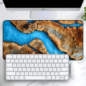 May include: A blue and brown abstract design mousepad with a white keyboard and mouse on top of it.