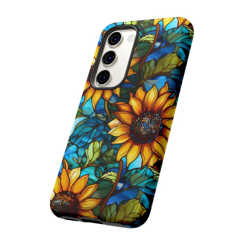 May include: A phone case with a stained glass design featuring sunflowers and leaves on a blue background.