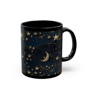 May include: Black ceramic mug featuring a celestial design. The mug's exterior showcases a dark blue background adorned with gold stars, a crescent moon, and intricate swirling patterns. The handle and interior are solid black.
