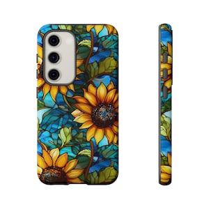May include: A phone case with a stained glass design featuring sunflowers and blue and green leaves.