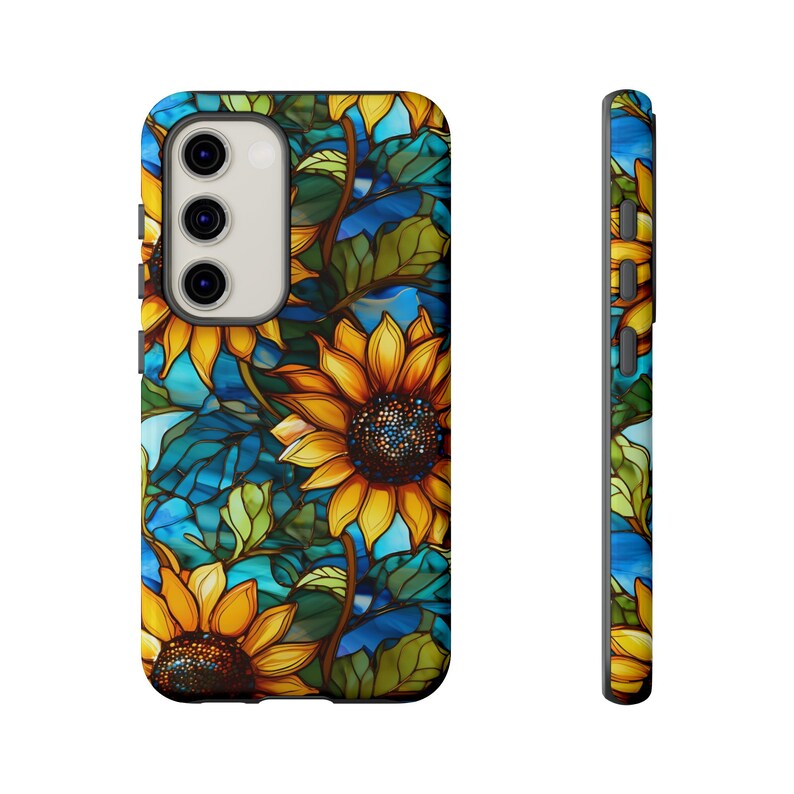 May include: A phone case with a stained glass design featuring sunflowers and blue and green leaves.