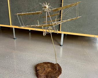 Vintage Toma Signed Brutalist Metal Biplane Kinetic Desktop Sculpture Midcentury Modern Space Age Wire Airplane Live Edge Walnut Base