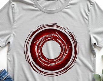 May include: A light gray t-shirt with a circular red and white design. The words "Sport Gray" are printed in black script at the top left. Blue jeans and a straw hat are next to the shirt.