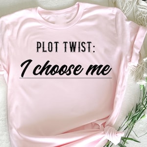 A bold "Plot Twist I Choose Me" t-shirt that celebrates self-love and empowerment. Perfect for anyone embracing confidence, personal growth, and choosing themselves. Comfortable cotton tee for daily wear and motivation.