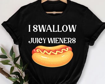May include: Black t-shirt with a white graphic of a hot dog and the text "I Swallow Juicy Wieners".