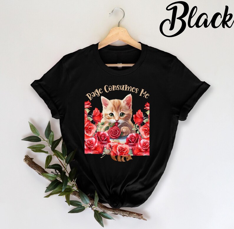 A playful "Rage Consumes Me" cat-themed T-shirt with a cute kitten and flower design. Perfect for meme lovers and cat enthusiasts, made of soft cotton for all-day comfort.