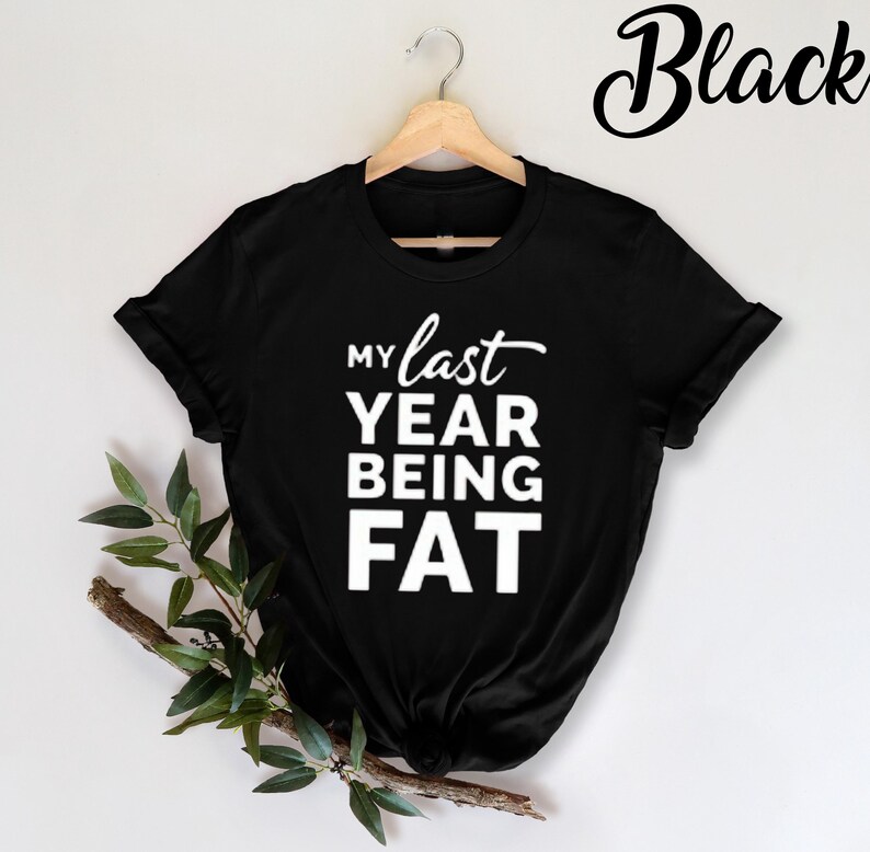 May include: Black t-shirt with white text that reads "My last year being fat".