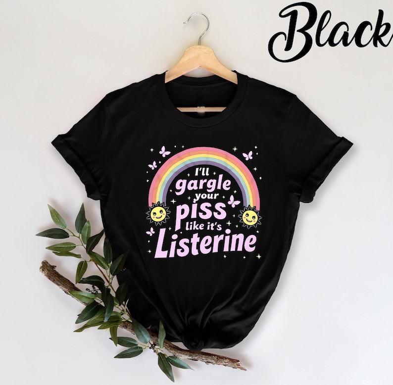 May include: Black t-shirt with a rainbow and the text "I'll gargle your piss like it's Listerine" in pink.