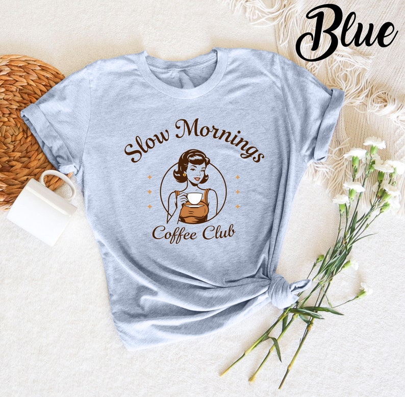 Funny "Slow Mornings Coffee Club" t-shirt for coffee lovers. Perfect for those who enjoy a relaxed, slow start to the day with a hot cup of coffee. A humorous shirt for anyone who appreciates their morning brew.