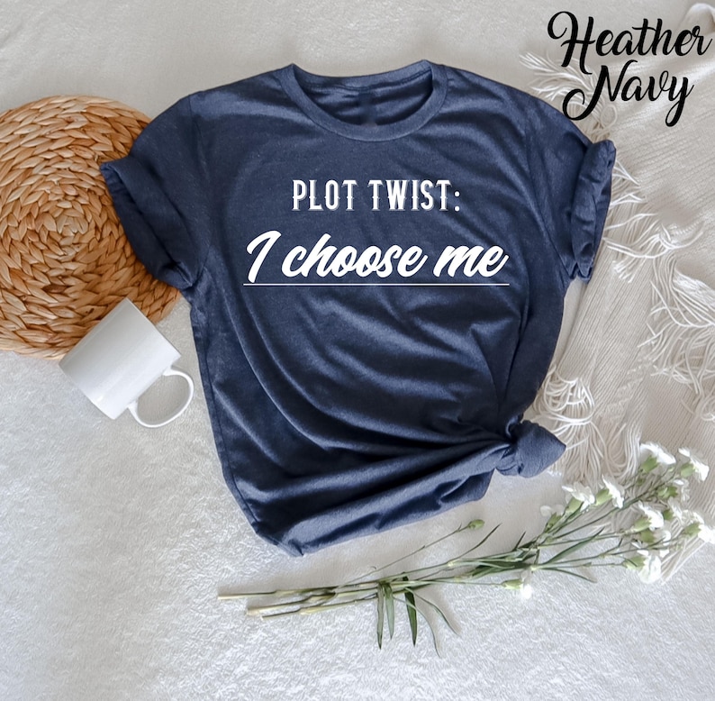 May include: A heather navy blue t-shirt with the text "PLOT TWIST: I choose me" printed in white.