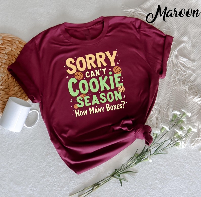 A funny and playful t-shirt for kids featuring the phrase "Cookie Dealer Scout for Girls Sorry Can’t Cookie Season." Perfect for young Girl Scouts or kids who love cookies and have a sense of humor. Ideal for cookie season or casual wear.