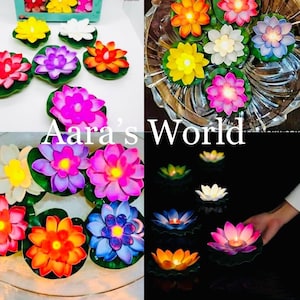 May include: Assortment of colorful floating lotus flower candles with LED lights. The candles are in various colors, including pink, purple, blue, yellow, orange, and white. The candles are arranged in a glass bowl and on a table.
