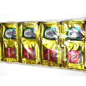 May include: A package of 10 gold foil packets of incense. Each packet has a green and white label with a temple image and the text "GOPURAM".