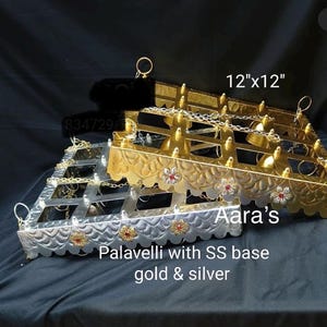 May include: Two decorative hanging racks, one gold and one silver, with a scalloped edge. The gold rack is 12 inches by 12 inches. The text "Aara's Palavelli with SS base gold & silver" is below the racks.