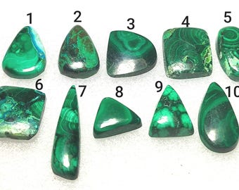 May include: Ten polished malachite gemstones in various shapes, including teardrop, oval, and triangular. The gemstones display a vibrant green color with unique swirling patterns. The stones are numbered 1 through 10.