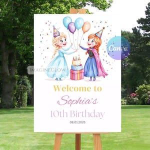 May include: A white sign on an easel with a watercolor illustration of two girls holding balloons and a birthday cake. The sign reads "Welcome to Sophia's 10th Birthday" with the date 08.01.2025. The background is a green lawn and trees.