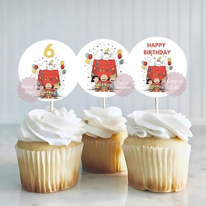 May include: Three cupcakes topped with white frosting, each with a circular Snoopy-themed topper. The toppers feature Snoopy on his doghouse, the number 6, and the words "Happy Birthday." The toppers also include the text "Ready to Print," "Digital Download," and "Easy to Edit."