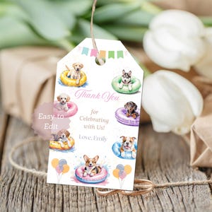 May include: A white gift tag with watercolor illustrations of puppies in colorful inflatable rings. The tag includes the text "Thank You for Celebrating with Us! Love, Emily" and is decorated with small flags and balloons.