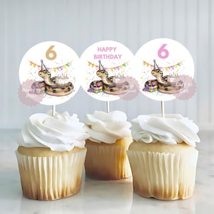 May include: Three cupcakes topped with white frosting, each adorned with a circular topper. The toppers feature a cartoon snake wearing a party hat, a cake, and the number "6" or the words "Happy Birthday". The text "Ready to Print", "Digital Download", and "Easy to Edit" are also visible.