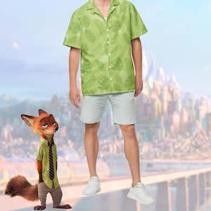 May include: A light green button-down shirt and light gray shorts. The shirt features a tropical leaf pattern. The person is wearing white sneakers. A cartoon fox character is standing to the left of the person.