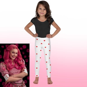 May include: White leggings with a red heart pattern. The leggings are on a young girl wearing a black shirt.