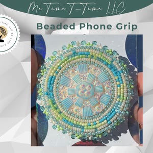 May include: A beaded phone grip with a blue, green, and white design. The beads are arranged in a circular pattern, creating a mandala-like design.