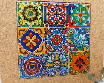May include: A cork-backed trivet with a colorful tile design featuring geometric patterns in shades of blue, red, yellow, green, and white. The tile design includes the word "Portugal".