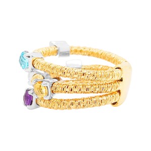 May include: A gold ring with three bands of woven wire, each band set with a different gemstone: a blue topaz, a yellow citrine, and a purple amethyst.