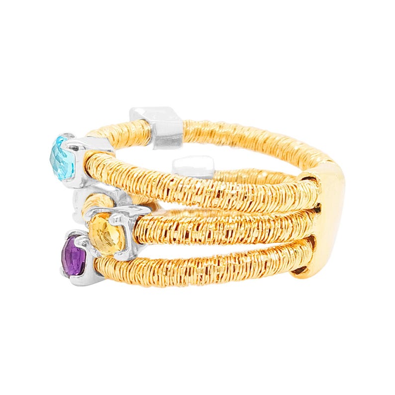 May include: A gold ring with three bands of woven wire, each band set with a different gemstone: a blue topaz, a yellow citrine, and a purple amethyst.