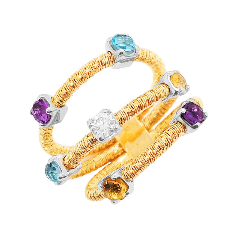 May include: A gold ring with a woven design and five gemstones. The gemstones are a clear diamond, a purple amethyst, a blue topaz, and two yellow citrines.