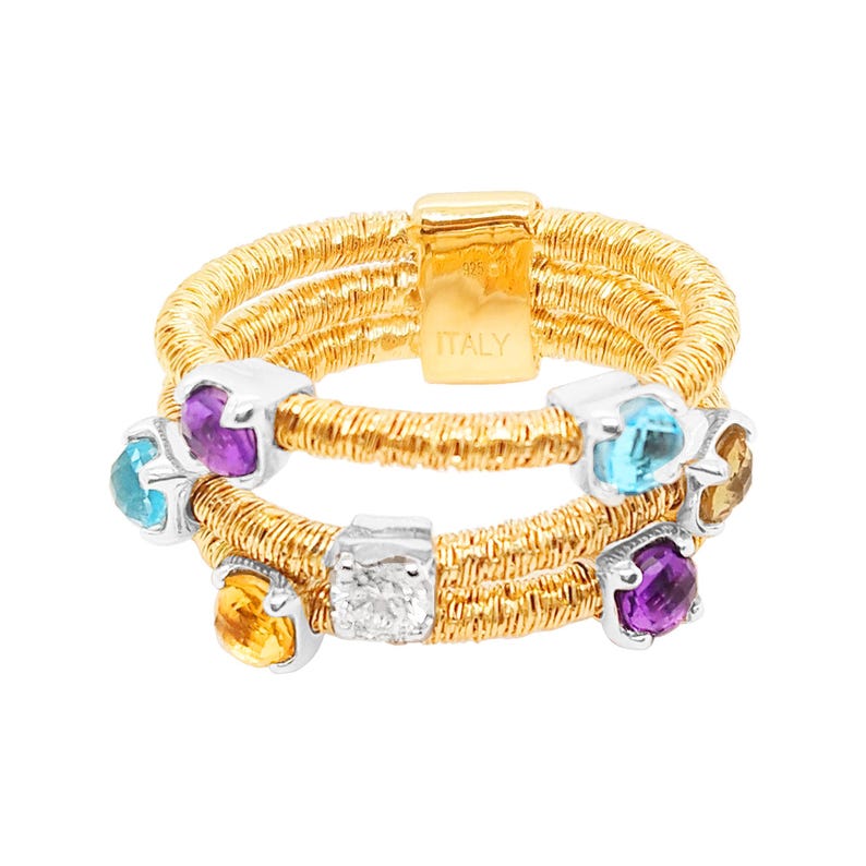 May include: A gold ring with multiple bands and colourful gemstones. The ring features a diamond, amethyst, topaz, and citrine stones. The ring is marked "ITALY" on the side.