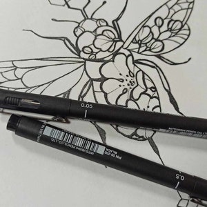 May include: A black and white line drawing of a bee with geometric patterns on its wings and body. The bee is drawn on a white sheet of paper with two black pens lying on top of the drawing. The pens are labeled "Pin 0.5-200 Black" and "Mitsubishi Pencil Co. Ltd."