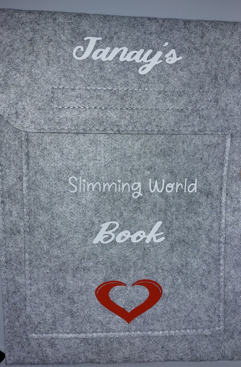 May include: A gray felt book bag with the text "Janay's Slimming World Book" and a red heart.