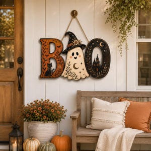May include: A hanging wall sign spelling the word BOO, where the letter B features a black cat, the letter O is replaced by a ghost wearing a witch hat, and the final O depicts a dark castle silhouette, all suspended by a thick jute rope.