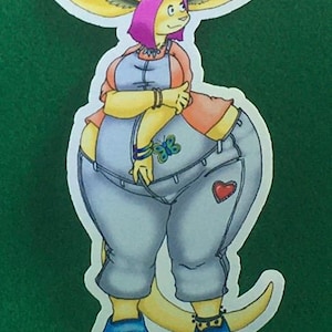 May include: A cartoon illustration of a yellow kangaroo wearing a light blue denim overall with a red heart patch, a pink shirt, and blue shoes. The kangaroo has pink hair and large ears.