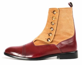 May include: Burgundy leather ankle boots with a tan suede panel and gold button accents.
