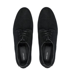 May include: A pair of black suede lace-up shoes with a leather sole. The shoes have a simple design and are branded "VALERO VENETO" on the inside.
