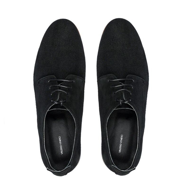 May include: A pair of black suede lace-up shoes with a leather sole. The shoes have a simple design and are branded "VALERO VENETO" on the inside.