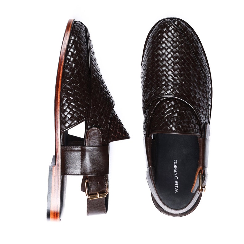 May include: A pair of brown leather sandals with a woven design. The sandals feature a buckle closure and a leather strap around the ankle. The sandals are made by the brand "Valerio Veneto".