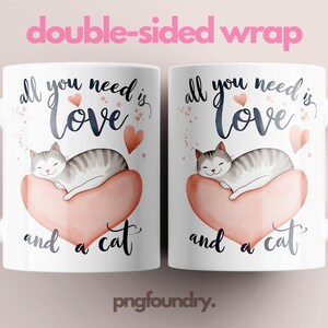 May include: White ceramic coffee mug with a pink heart and a sleeping cat illustration. The text on the mug reads "All you need is love and a cat."