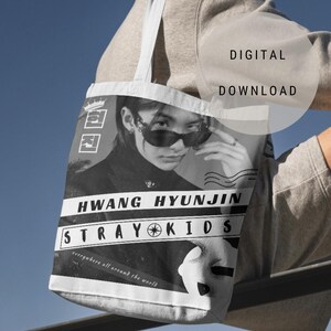 May include: A black and white tote bag featuring a photograph of a person wearing sunglasses. The bag has the text "HWANG HYUNJIN STRAY KIDS" printed on it, along with the phrase "everywhere all around the world".