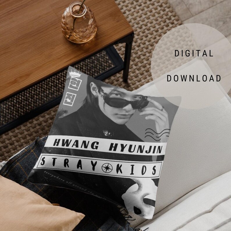 May include: Black and white cushion featuring a photo of a person wearing sunglasses with the text "HWANG HYUNJIN STRAY KIDS" printed on the cushion.